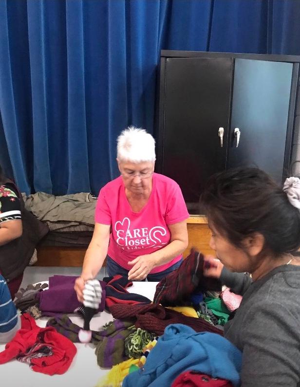 Volunteer helping sort clothing